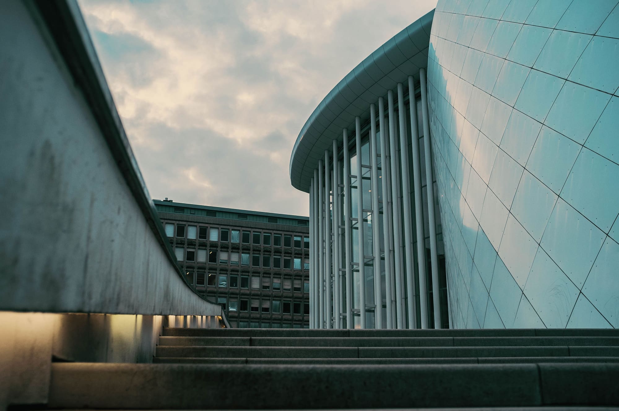 Colonnade of a modern building against a cloudy sky
