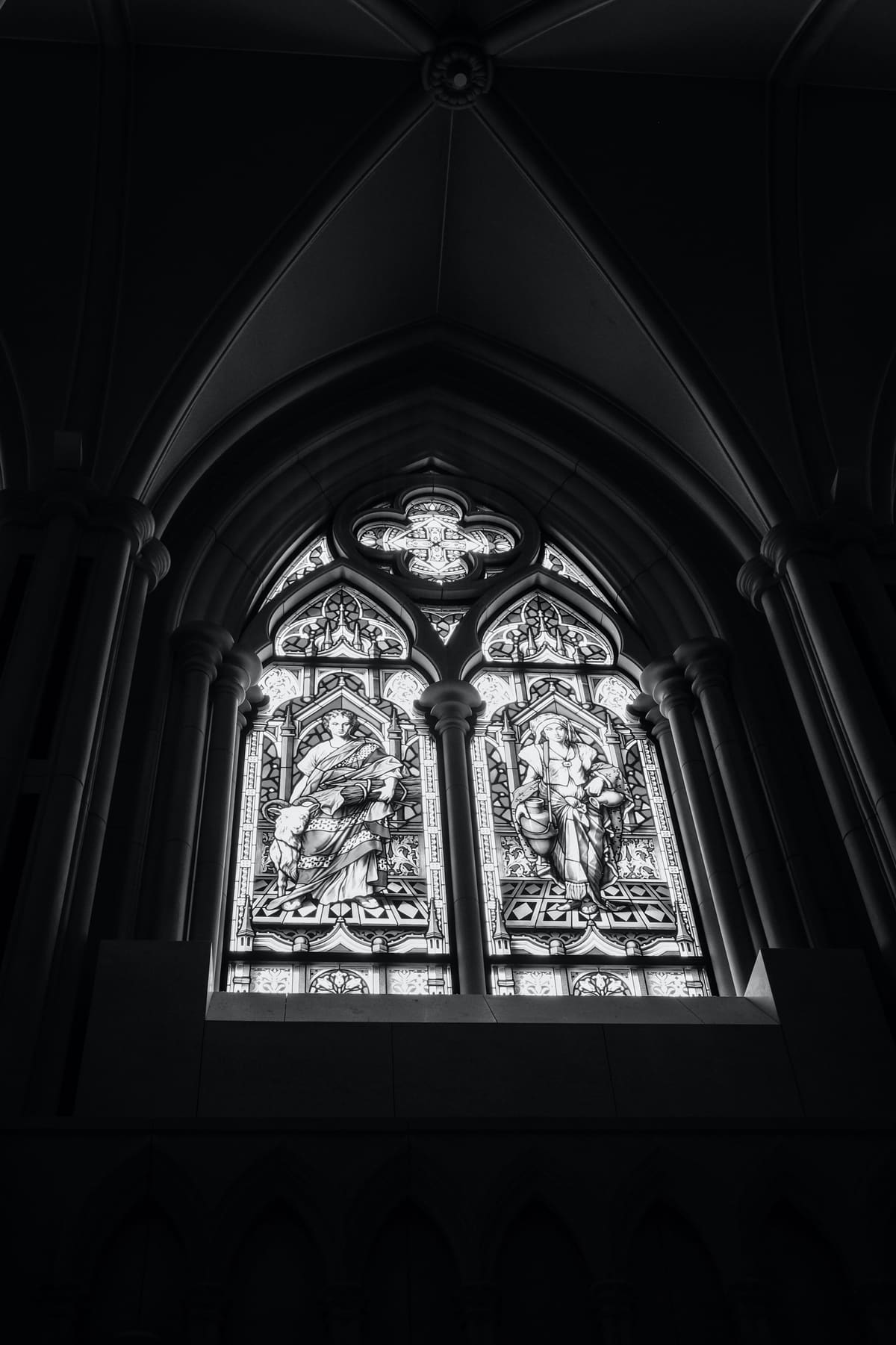 Church window with two figures, in black and white